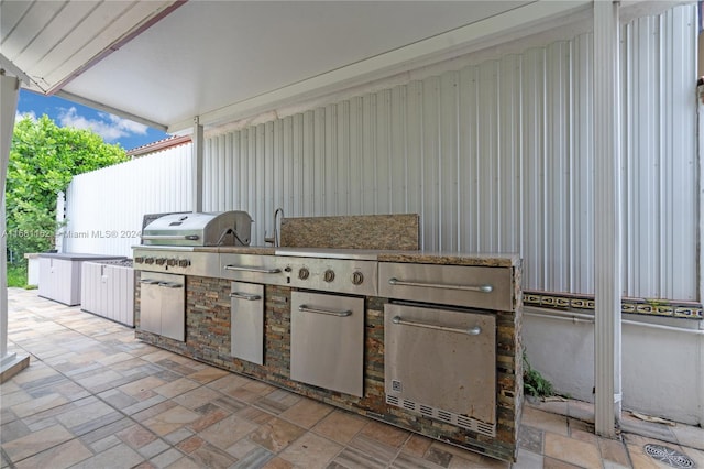 view of patio / terrace with area for grilling and a grill