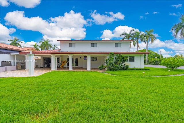 rear view of property featuring a lawn