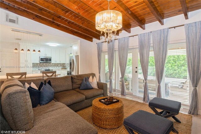 8135 SW 136th St, Pinecrest, FL 33156 - living area with a chandelier, wood ceiling, and healthy amount of natural light