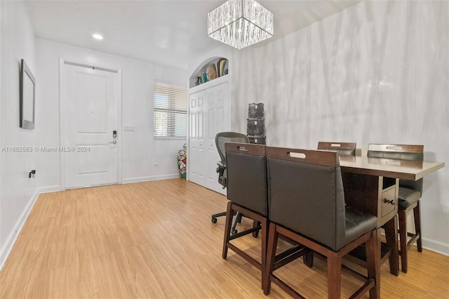 office space featuring a notable chandelier and wood-type flooring