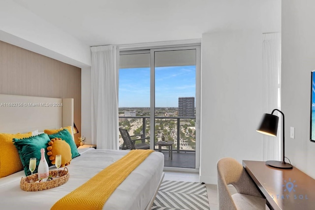 bedroom with floor to ceiling windows, multiple windows, and access to exterior