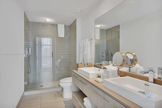 bathroom featuring vanity, tile patterned floors, toilet, and walk in shower