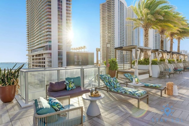 balcony featuring an outdoor living space and a water view