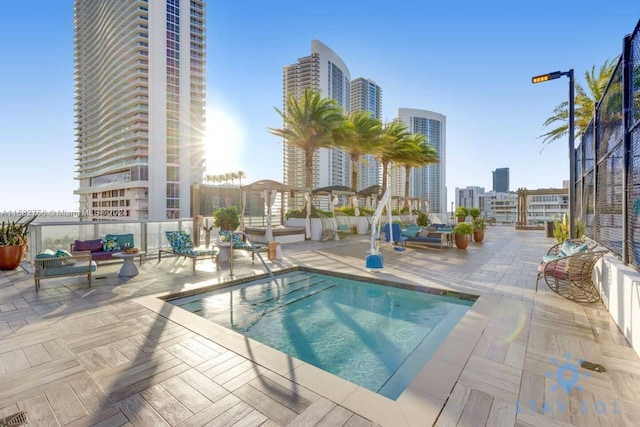 view of pool featuring an outdoor hangout area and a patio