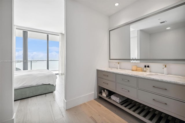 bathroom with a water view, hardwood / wood-style flooring, and vanity