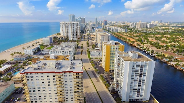 drone / aerial view featuring a water view and a view of the beach