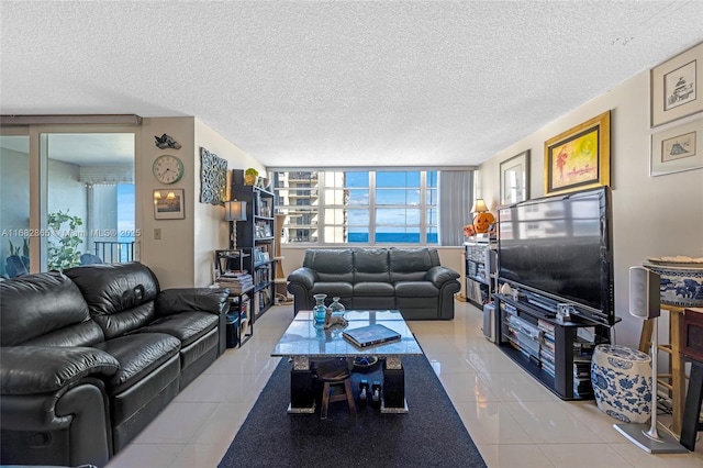 tiled living room featuring a textured ceiling