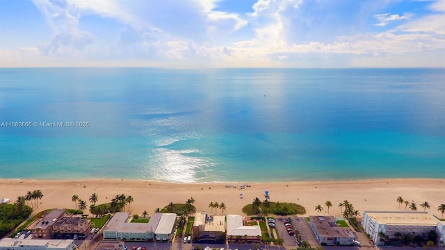 aerial view with a water view and a beach view