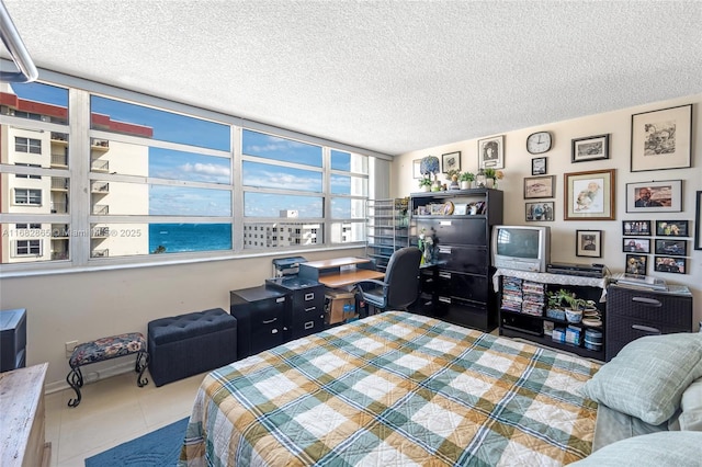 bedroom with tile patterned flooring and a textured ceiling