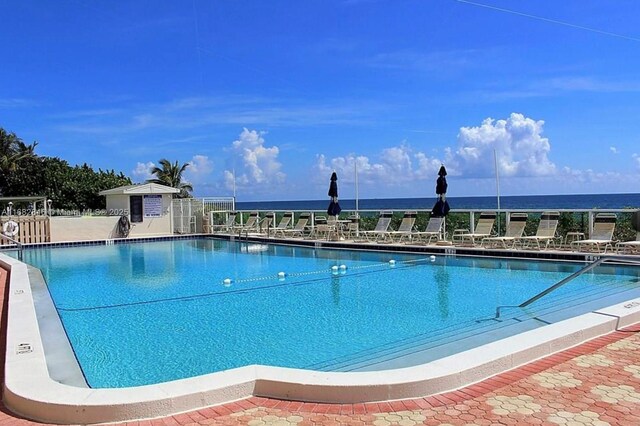 view of pool featuring a water view