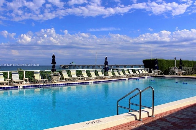 view of swimming pool with a water view