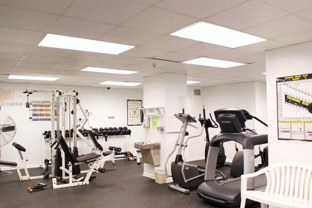 exercise room featuring a paneled ceiling