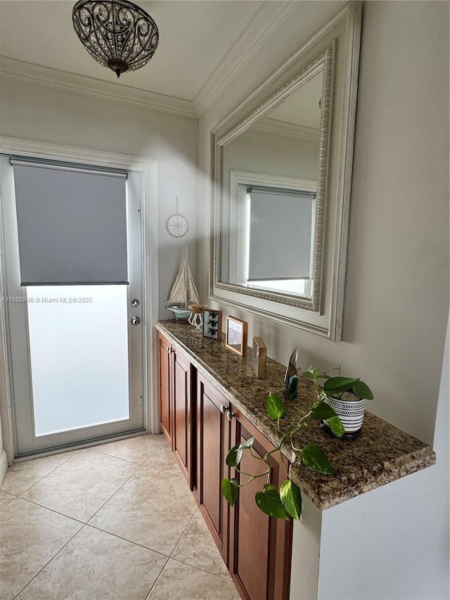 interior space with light tile patterned floors and crown molding