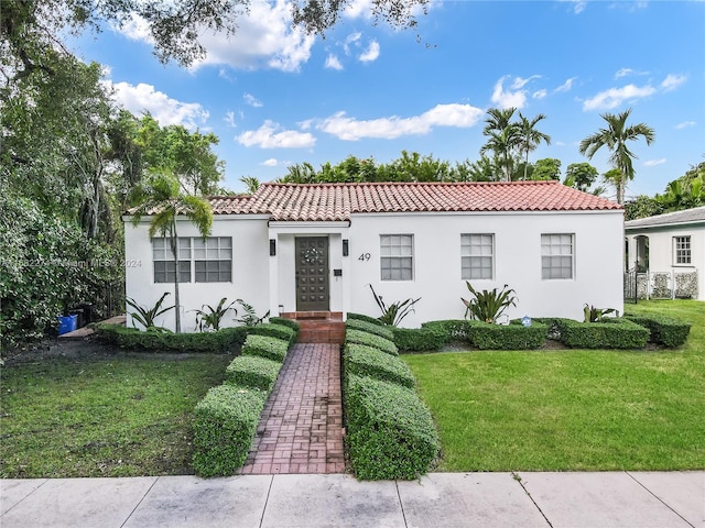 mediterranean / spanish-style home featuring a front yard