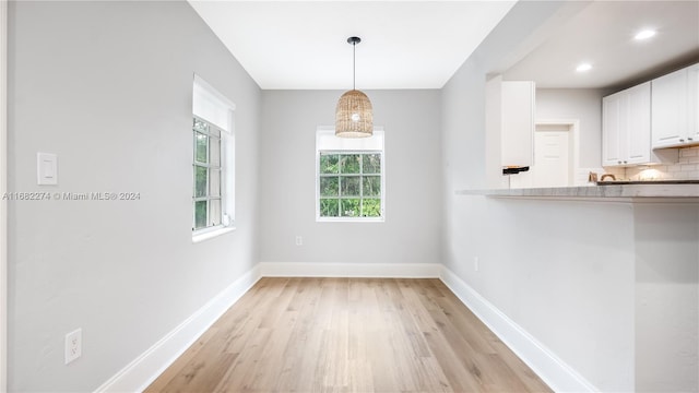 unfurnished dining area with light hardwood / wood-style floors