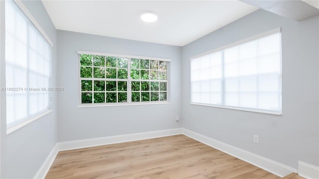 empty room with light hardwood / wood-style flooring