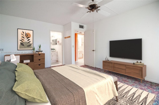 bedroom with carpet flooring, ensuite bathroom, and ceiling fan