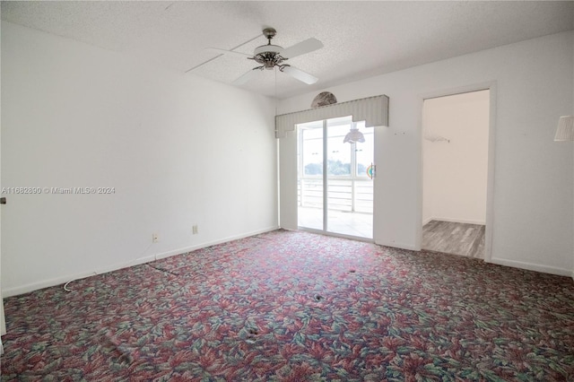 unfurnished room featuring carpet flooring, ceiling fan, and a textured ceiling