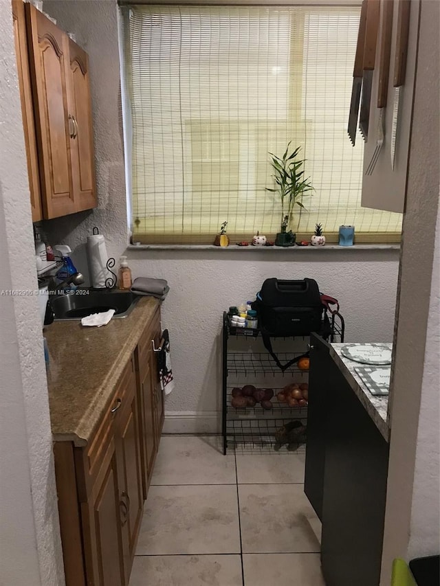 bathroom with sink and tile patterned flooring