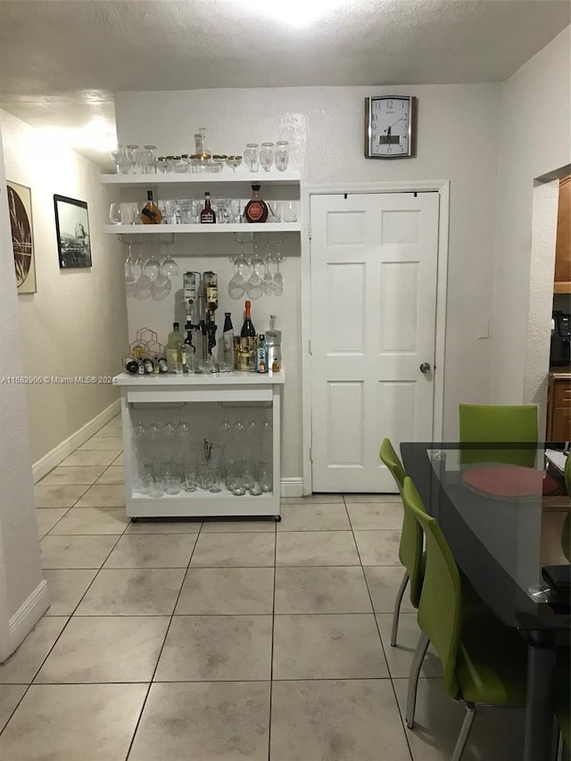 bar featuring light tile patterned floors