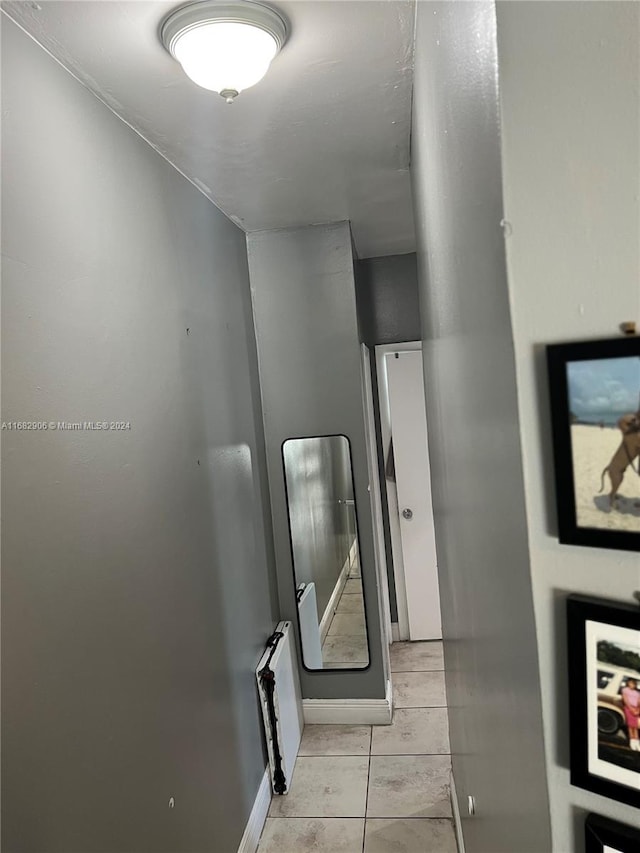 corridor featuring light tile patterned flooring