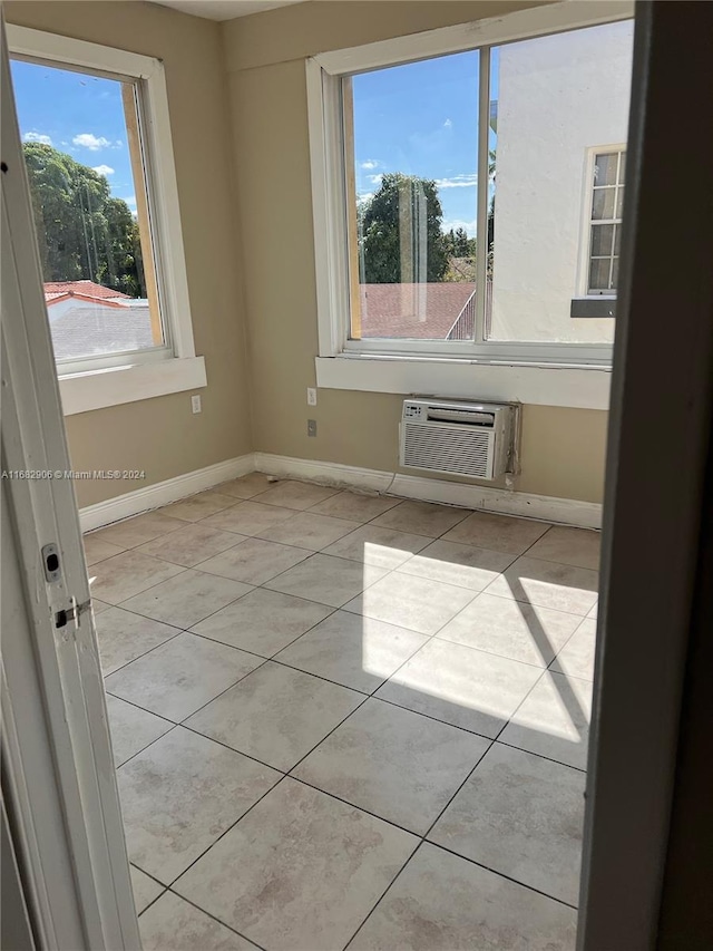 tiled empty room with an AC wall unit