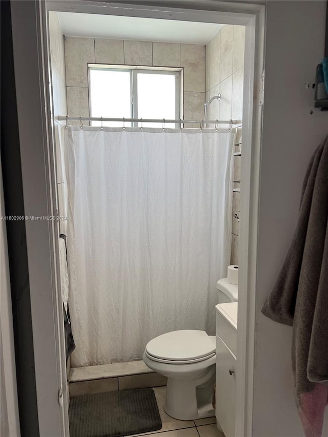 bathroom featuring toilet, curtained shower, vanity, and tile patterned floors