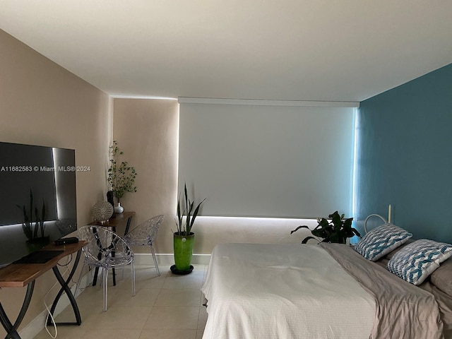 bedroom with light tile patterned floors