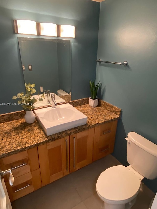 bathroom with vanity, toilet, and tile patterned floors