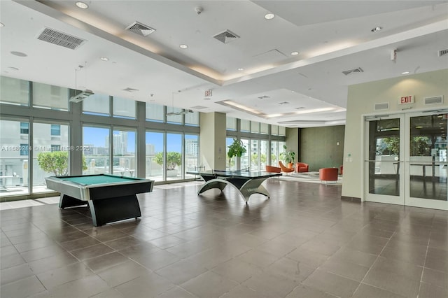 game room featuring french doors, billiards, a tray ceiling, a towering ceiling, and tile patterned flooring