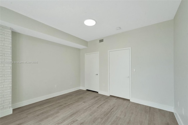 empty room with light hardwood / wood-style floors