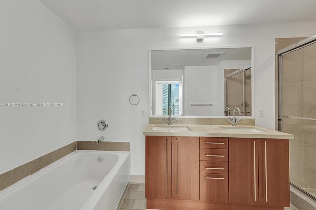 bathroom with tile patterned flooring, vanity, and plus walk in shower