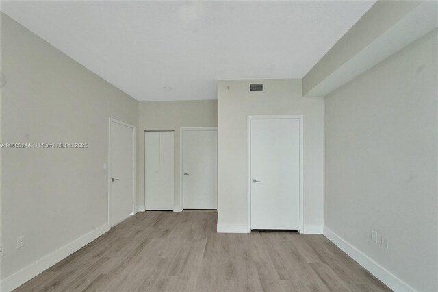 unfurnished bedroom with light wood-type flooring