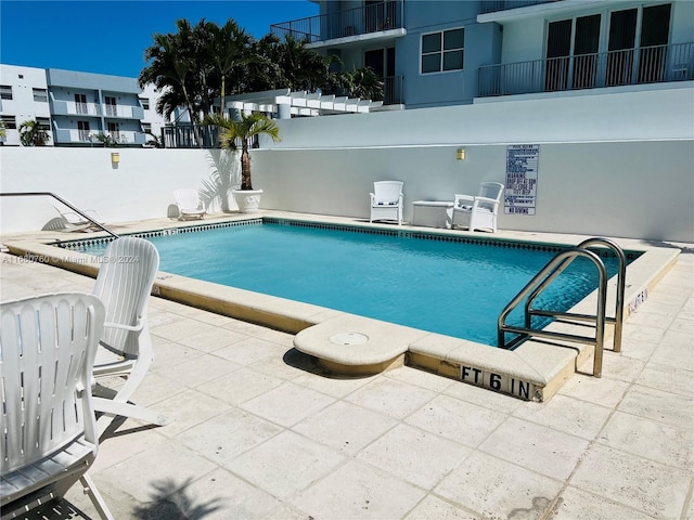 view of swimming pool featuring a patio area