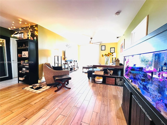 recreation room featuring ceiling fan and light hardwood / wood-style floors