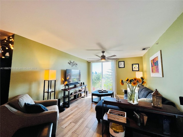 living room featuring light hardwood / wood-style floors and ceiling fan