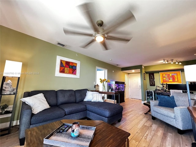 living room with hardwood / wood-style floors and ceiling fan