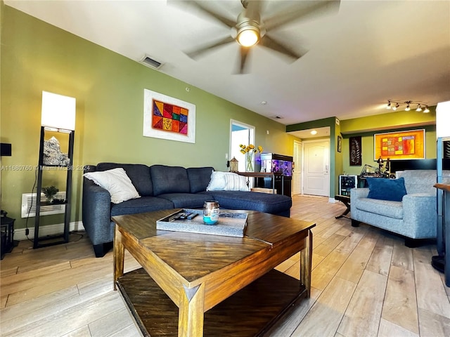 living room with light hardwood / wood-style flooring and ceiling fan