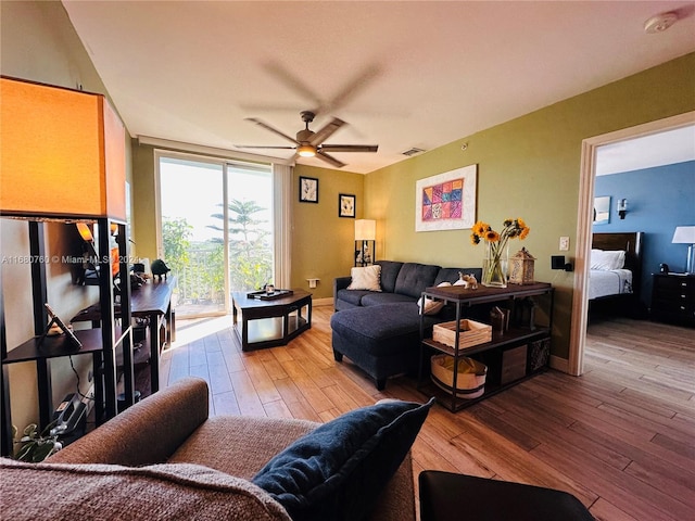 living room with ceiling fan and hardwood / wood-style floors