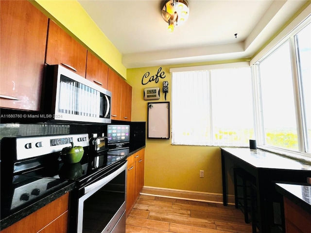 kitchen featuring decorative backsplash, appliances with stainless steel finishes, and light hardwood / wood-style flooring