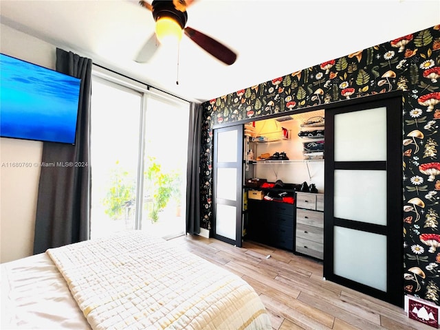 bedroom featuring ceiling fan, a closet, and light hardwood / wood-style floors