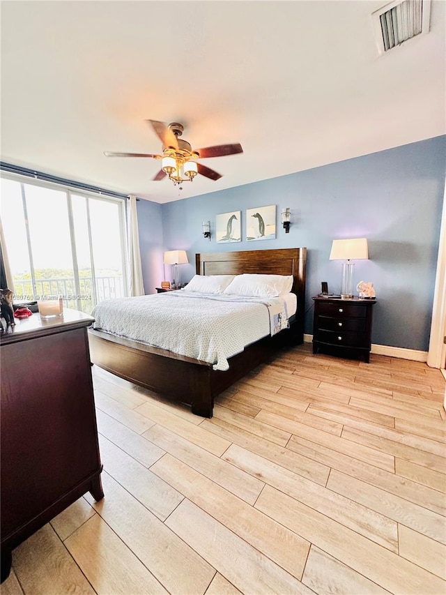 bedroom featuring ceiling fan and light hardwood / wood-style flooring