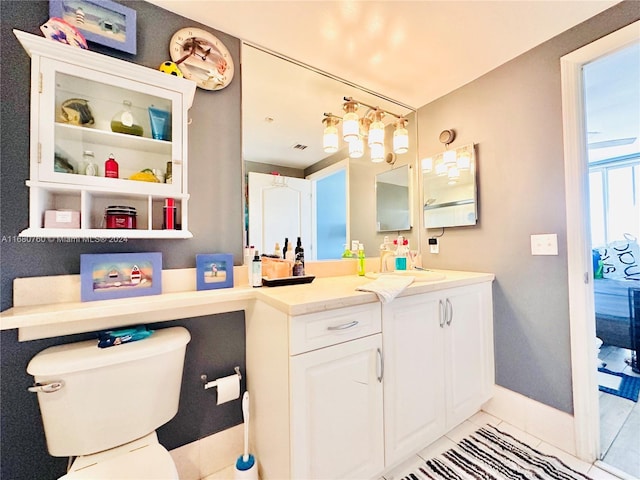 bathroom featuring tile patterned floors, vanity, and toilet