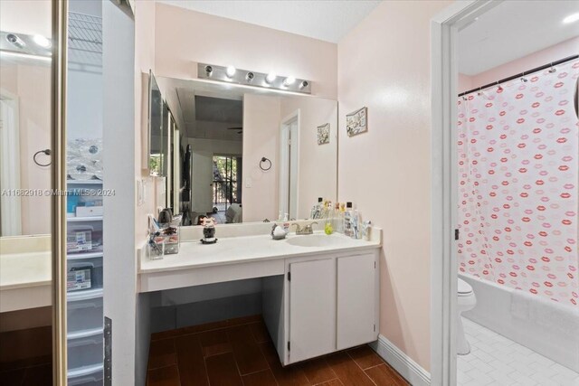 full bathroom featuring vanity, hardwood / wood-style flooring, toilet, and shower / tub combo