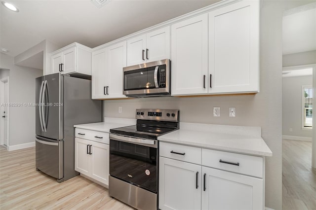 kitchen with white cabinetry, appliances with stainless steel finishes, and light wood-type flooring