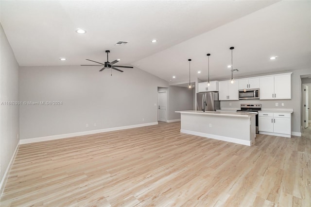 kitchen with light hardwood / wood-style flooring, stainless steel appliances, a center island with sink, and vaulted ceiling