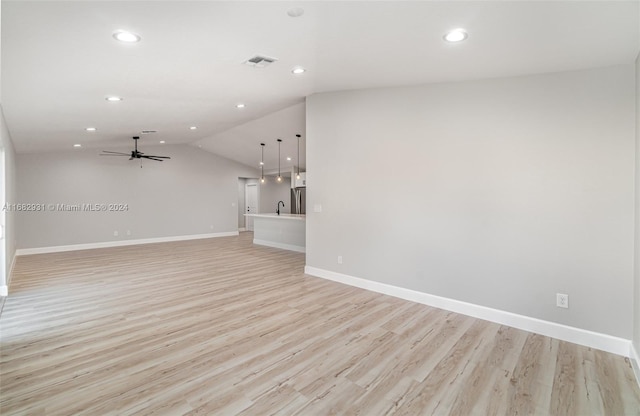 unfurnished living room with lofted ceiling, light wood-type flooring, and ceiling fan