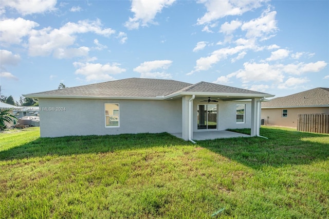 rear view of house featuring ceiling fan, a lawn, and a patio area