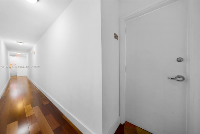 hallway with wood-type flooring