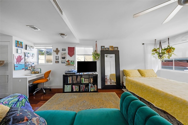 bedroom featuring built in desk and dark wood-type flooring